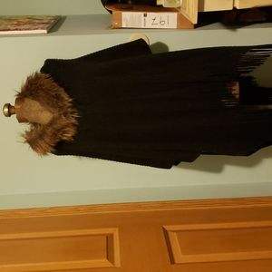Unique cape with fringe detsil. Faux collar. Snap button. Open sleeves.